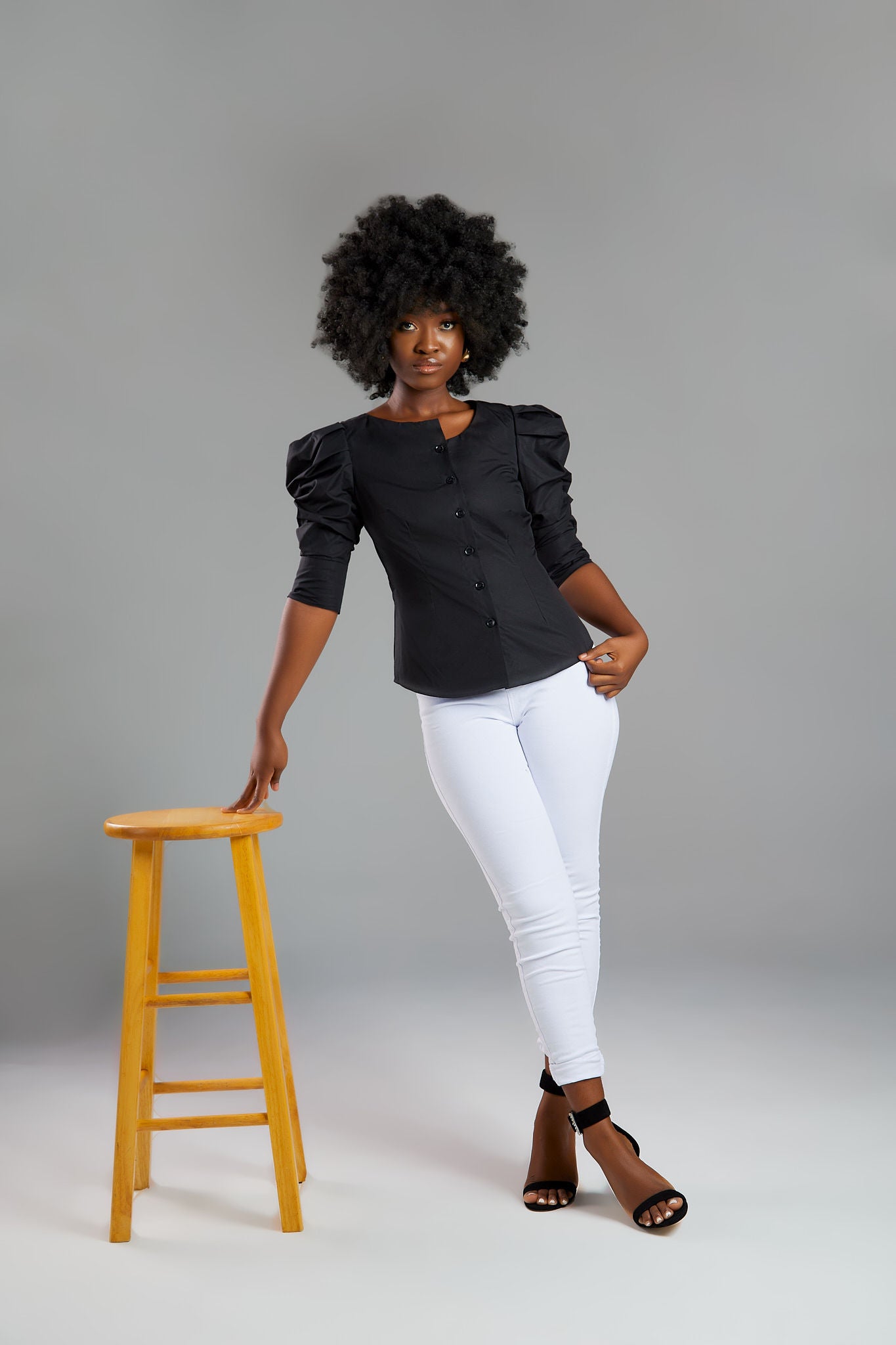 Seragyi's Martina Blouse in Black, made from sustainable cotton. With a modern asymmetrical neckline and ruched sleeves, this elegant design is a must-have in Women's Clothing.
