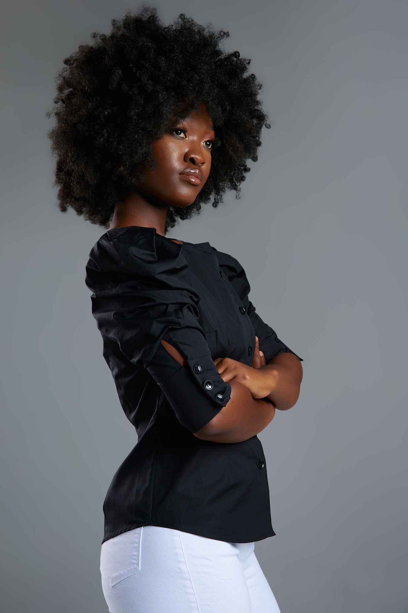 Seragyi's Martina Blouse in Black, made from sustainable cotton. With a modern asymmetrical neckline and ruched sleeves, this elegant design is a must-have in Women's Clothing.