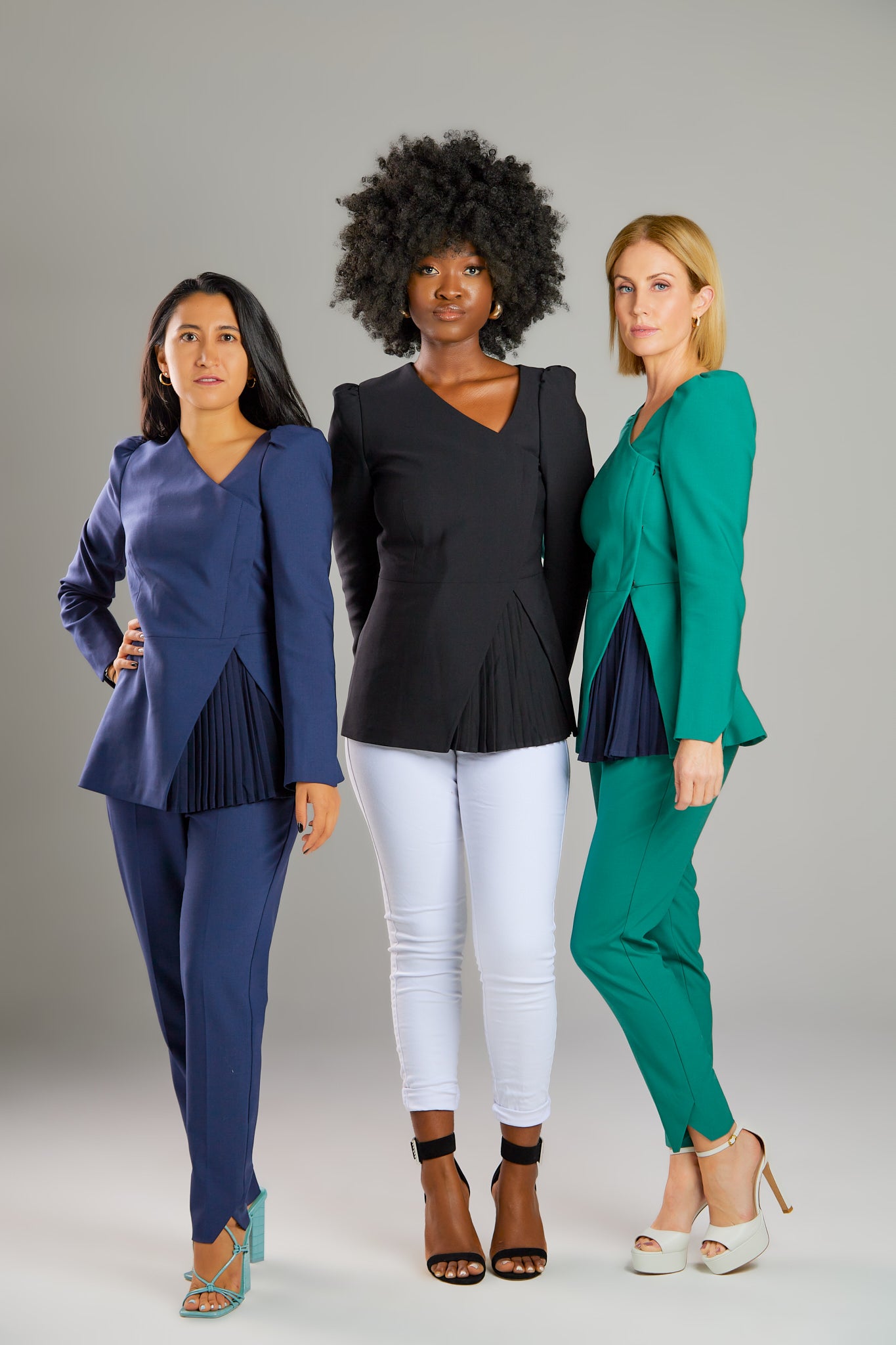 Seragyi's Liz Peplum Jacket in Women's Clothing line, made of wrinkle-resistant Italian Merino wool, showcasing Women's Jackets' sophistication, quality, and sustainability. A prime example of Women's Suits, it features an asymmetrical neckline, pyramid-cut sleeves, and a partially pleated peplum. Ideal for travel and versatile styling, from monochrome looks to skinny jeans and heels for evening wear.