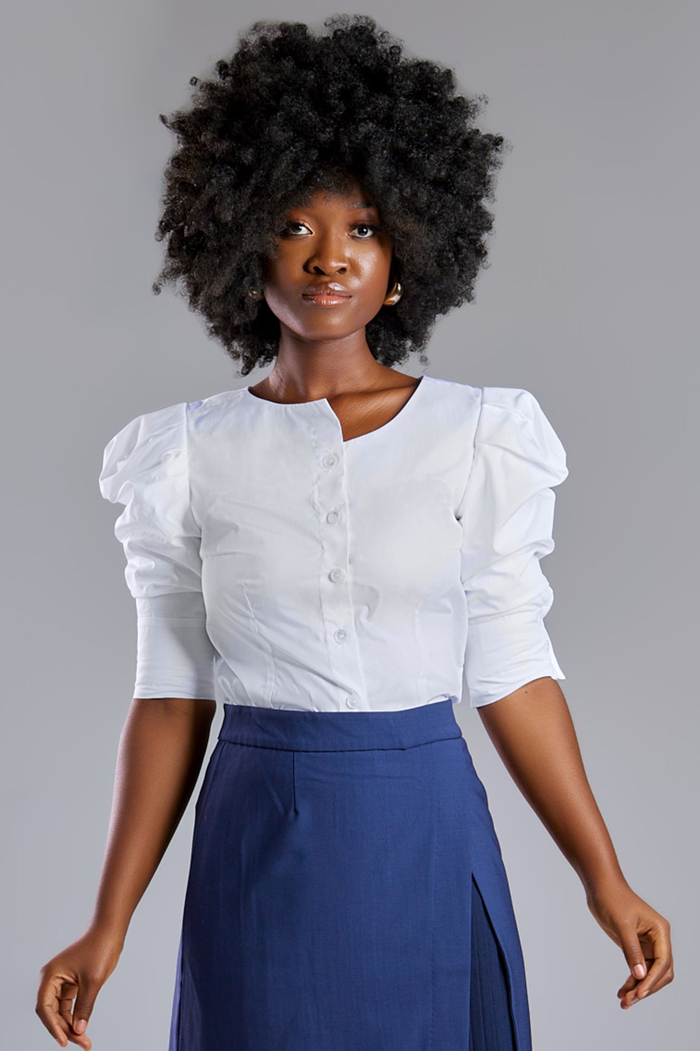 Seragyi's Martina Blouse in White, crafted from 100% eco-friendly cotton. Featuring an asymmetrical neckline and ruched sleeves, it's a versatile and elegant piece in Women's Clothing.