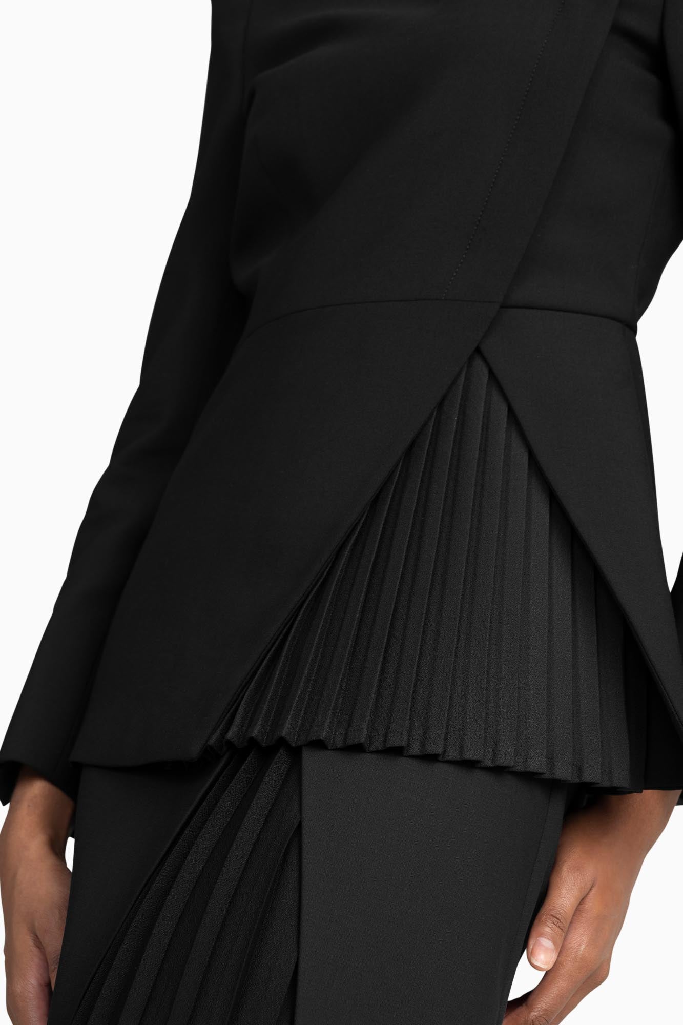 Seragyi's Liz Peplum Jacket in Women's Clothing line, made of wrinkle-resistant Italian Merino wool, showcasing Women's Jackets' sophistication, quality, and sustainability. A prime example of Women's Suits, it features an asymmetrical neckline, pyramid-cut sleeves, and a partially pleated peplum. Ideal for travel and versatile styling, from monochrome looks to skinny jeans and heels for evening wear.